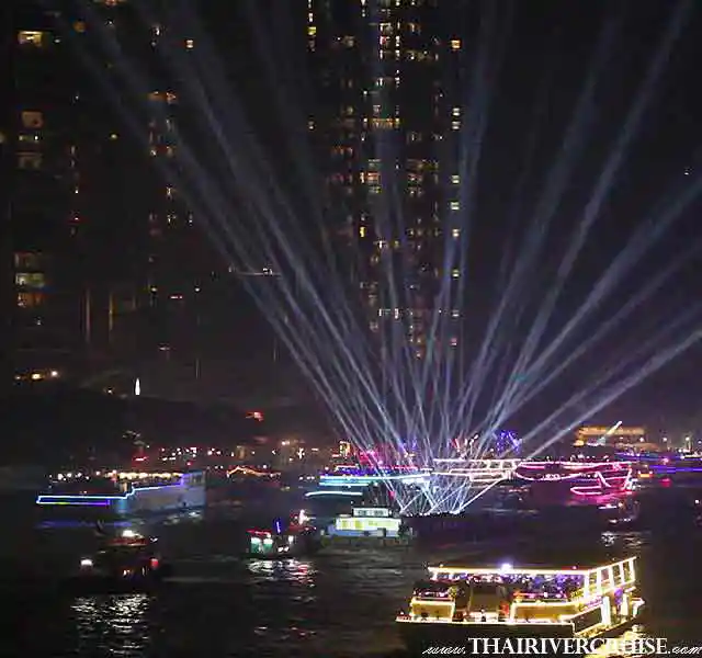 Focus on spectacular, dynamic laser beams and light show patterns in blue and white, radiating from dinner cruise boats on the Chao Phraya River against the backdrop of lit cityscape.