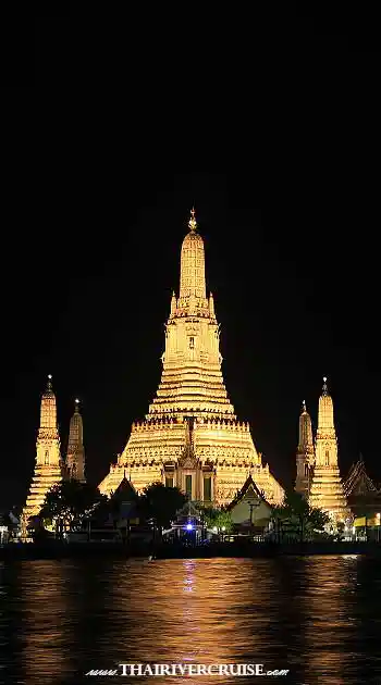 Illuminated dinner cruise boats sailing past Bangkok's riverside skyline on the Chao Phraya River at night. Vertical photograph of the intricately carved central prang of Wat Arun (Temple of Dawn) brightly illuminated in warm golden light against a pure black night sky. Its reflection shimmers on the dark surface of the Chao Phraya River, with smaller chedis visible on either side. Illuminated dinner cruise boats sailing past Bangkok's riverside skyline on the Chao Phraya River at night. Vertical photograph of the intricately carved central prang of Wat Arun (Temple of Dawn) brightly illuminated in warm golden light against a pure black night sky. Its reflection shimmers on the dark surface of the Chao Phraya River, with smaller chedis visible on either side.